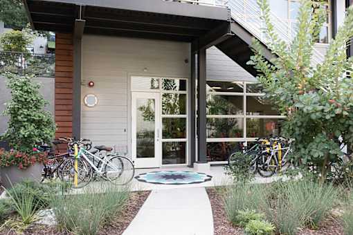 A modern house with a bicycle parked in front.