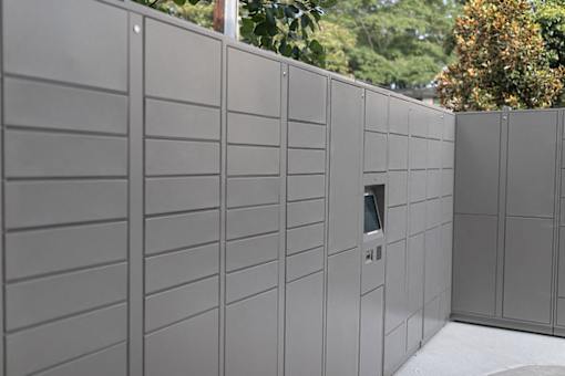 A wall of grey lockers with a door on the side.