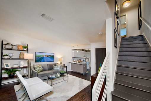 A living room with a white chair and a grey couch.