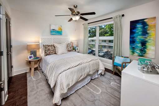 a bedroom with a bed and windows