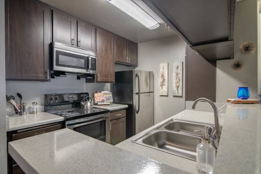 Kitchen view with built-in microwave at Monterra Ridge Apartments, Canyon Country ,91351