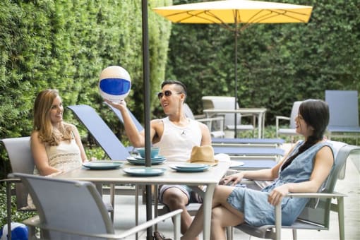 People relaxing outdoors at Wilshire Vermont, Los Angeles, 90010