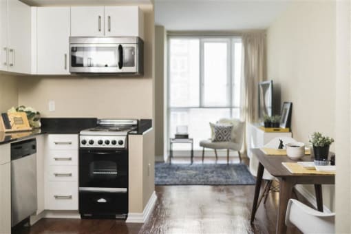 Kitchen with stove and table at Wilshire Vermont, Los Angeles, CA