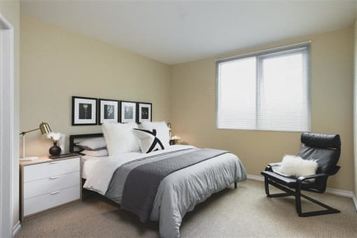 Bedroom with modern recliner chair at Wilshire Vermont, Los Angeles, California