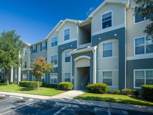 Apartment Building Exterior with Parking Lot at Camri Green Apartments, Jacksonville, FL, 32257