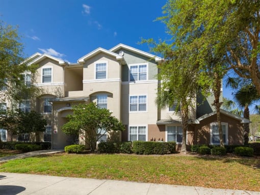 Apartment building exterior surrounded by native landscaping