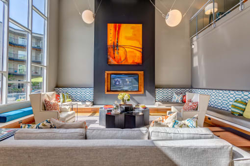 a living room with a large couch and a fireplace at Artisan Twickenham Square, Huntsville, 35801