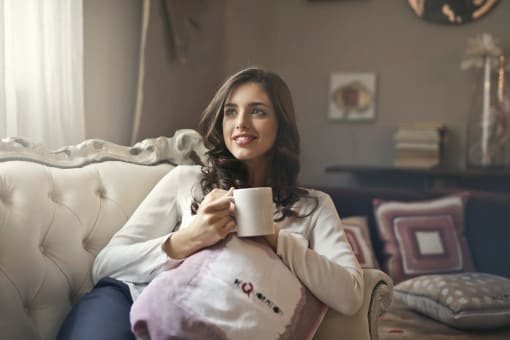 Woman relaxing in Spacious living room at Aberdeen of Brighton Apartments