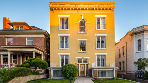 Yellow exterior of First Avenue Homes