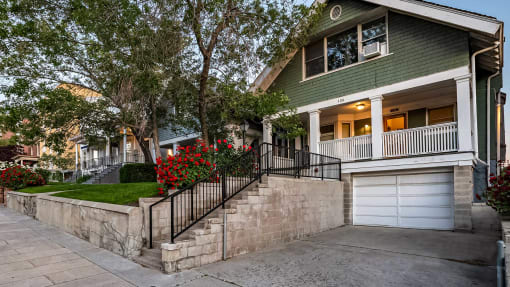 Side exterior of green First Avenue Home with an attached garage