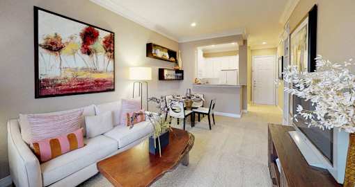 Spacious living room, spacious dining room, kitchen with granite countertops, white cabinets, and breakfast bar at Tuscany Court Apartments in Houston.