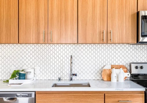 Tile backsplash and walnut finish cabinets