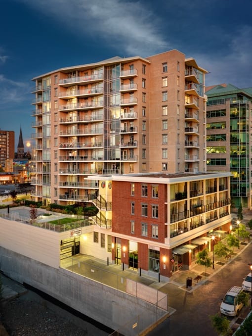 a rendering of a large apartment building in a city at night #victoria #rentals #affordable #apartments