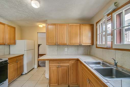 a kitchen with wooden cabinets and a sink