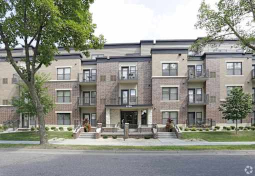 Apartment buildings with trees in front of them.