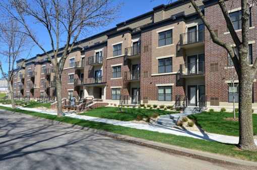 Apartment buildings with trees in front of them.