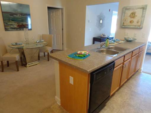 alternate angle of kitchen with sink and dishwasher