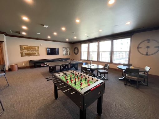 a game room with a foosball table and a ping pong table