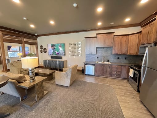 a kitchen and living room with a tv in the clubhouse