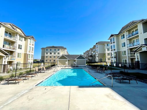 a swimming pool in front of an apartment building