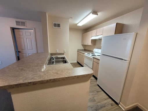 Kitchen with cabinets at MADISON MANOR, JACKSONVILLE, Florida