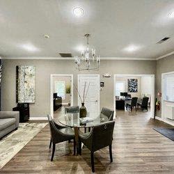 a dining room with a glass table and chairs at Hidden Creek, Morrow, Georgia