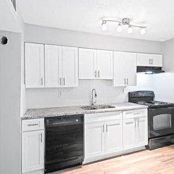 an empty kitchen with white cabinets and black appliances at Uphill Flats, Decatur, GA, 30032