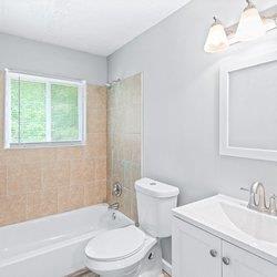 a bathroom with a bath tub and a green rug at Uphill Flats, Decatur, GA