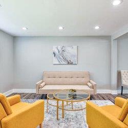 a living room with couches and chairs and a glass coffee table at Uphill Flats, Georgia