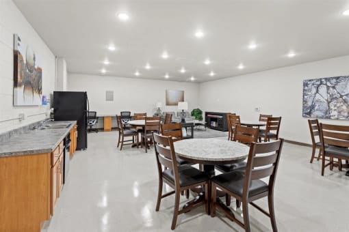 tables and chairs and a kitchenette in Muskego School's community room