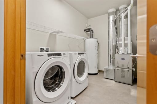 a washer, dryer, hot water heater, and HVAC in a home at Muskego School Apartments