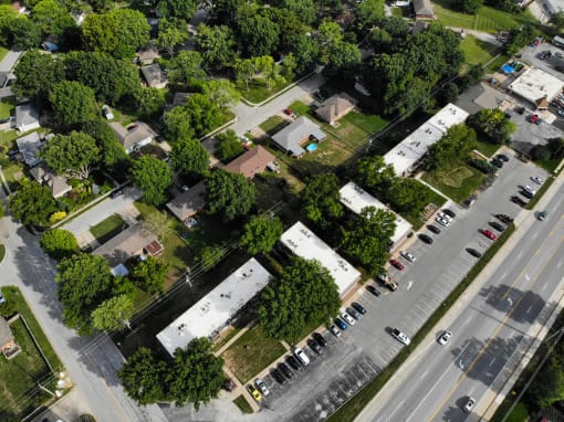 an aerial view of a neighborhood with cars and trees