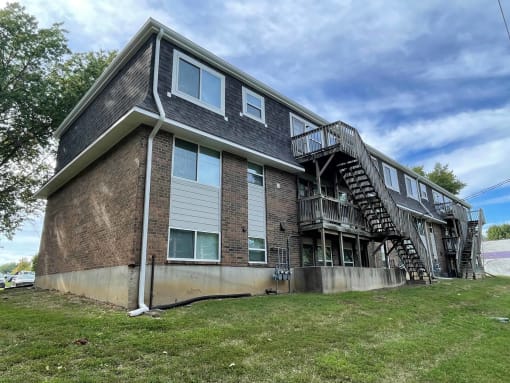 a brick apartment building with stairs on the side of it