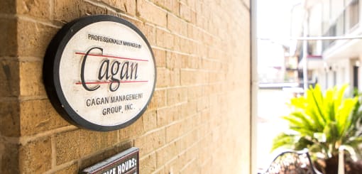 A sign on a wall that says cagan management group