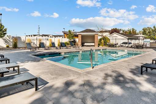 Swimming Pool with lounge seating surrounding perimeter at Eagles Landing, Ammon, Idaho