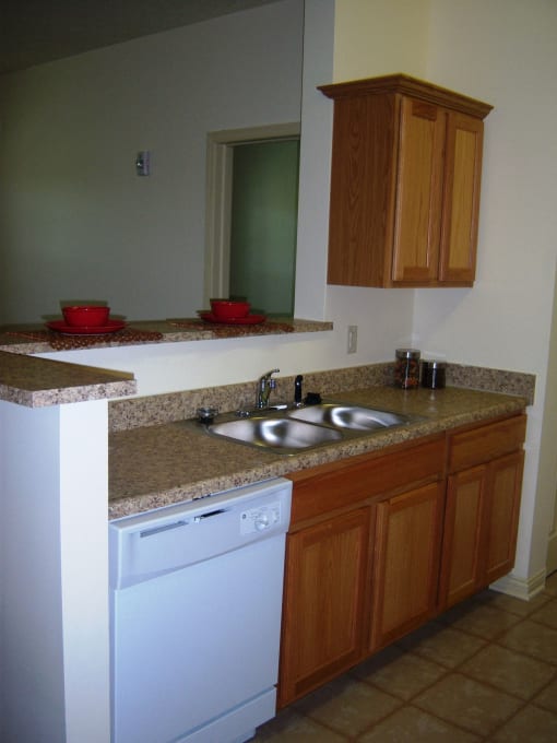 Kitchen, solid surface countertops, white appliances, tile flooring