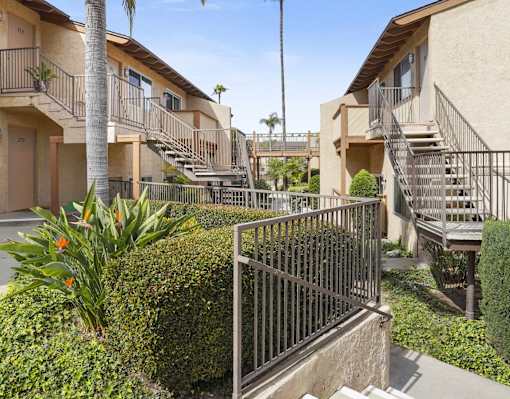A sunny day at a residential complex with a clear blue sky.