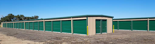 a row of storage units with green doors