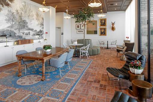 A living room with a large rug and a wooden table at The Fitz Apartments, OR 97210