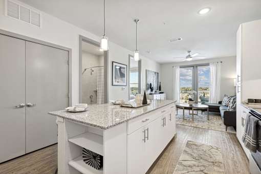 Living room with white kitchen island and granite countertops, Ironcrest, Texas
