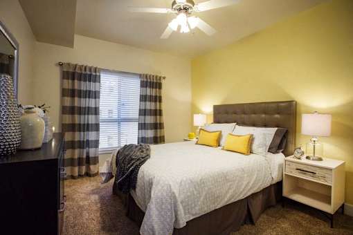 Liberty Gateway Apartments, Salt Lake City, Utah, bedroom with a bed, nightstand, and window.