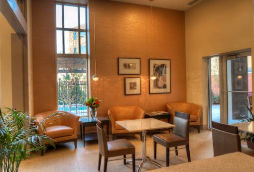 Liberty Gateway Apartments, Salt Lake City, Utah, kitchenette with a table and chairs and a vase of flowers on the table.