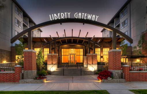 Liberty Gateway Apartments, Salt Lake City, Utah, entrance to the Liberty Gateway building is adorned with lights and red flowers.