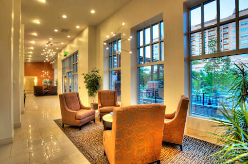 Liberty Gateway Apartments, Salt Lake City, Utah, a lounge area with chairs and plants on either side.