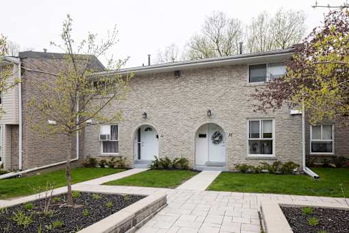 Brick building with white doors and windows.