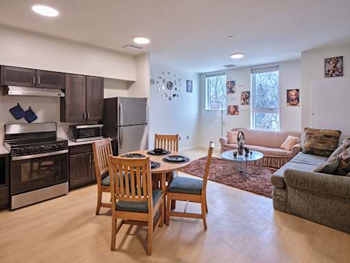 A kitchen with a table and chairs in the middle of the room.