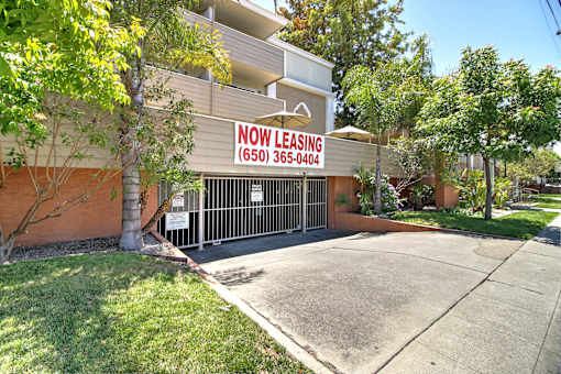 A building with a leasing sign on it.
