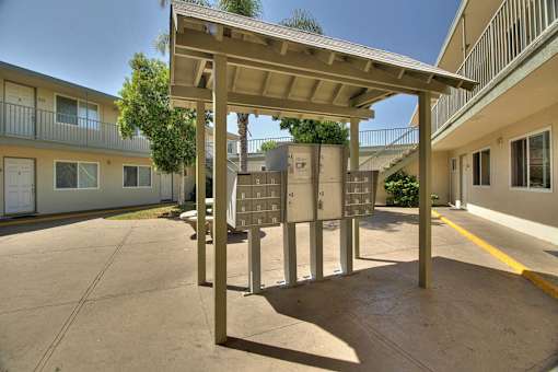 a covered parking lot with several mailboxes