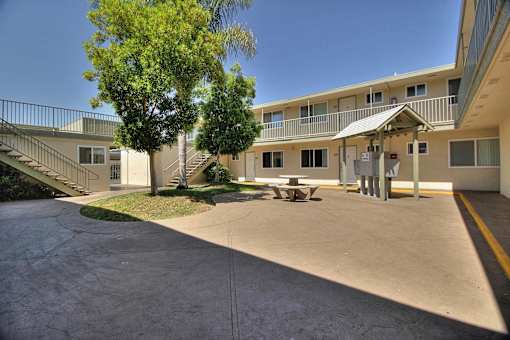the courtyard with a picnic table in front of a building