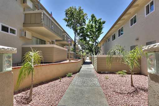 A pathway leads between two rows of buildings.
